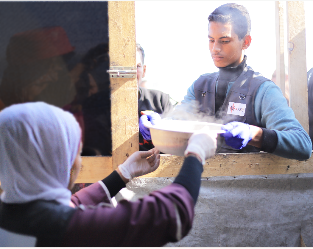 AFSC's team in Gaza distribute food at an open-air kitchen in Rafah, Gaza